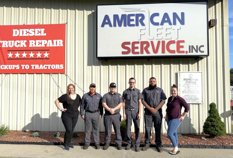 American Fleet Service staff group photo in front of company sign